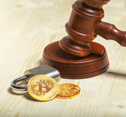 A gavel next to golden Bitcoin coins, symbolizing the U.S. Department of Justice’s decision to dismantle its crypto enforcement unit after a Trump executive order.