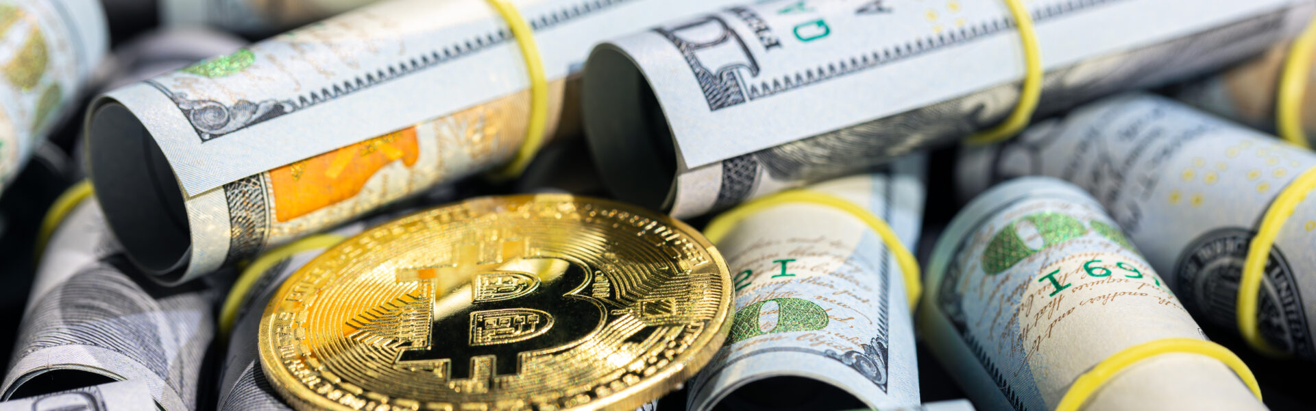 Bitcoin placed on rolled U.S. dollar bills, symbolizing the shifting financial landscape as crypto gains traction amid global tariff policies.