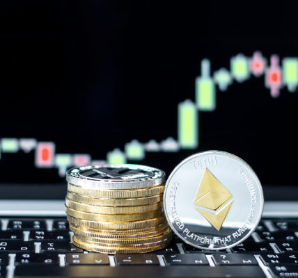 A close-up of stacked coins with a prominent silver Ethereum (ETH) token in focus, placed in front of a glowing candlestick chart showing market volatility and potential recovery trends.
