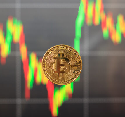 Single Bitcoin in focus with a blurred, falling candlestick chart in the background, symbolizing market panic and asset sell-offs.