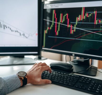 Multiple monitors showing technical analysis charts with sharp trendlines, suggesting a possible breakout in XRP.
