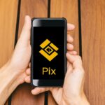 Binance Pay linked with Pix network over a Brazil map, showing real-time crypto payments reaching millions of users, symbolizing enhanced financial access and speed.